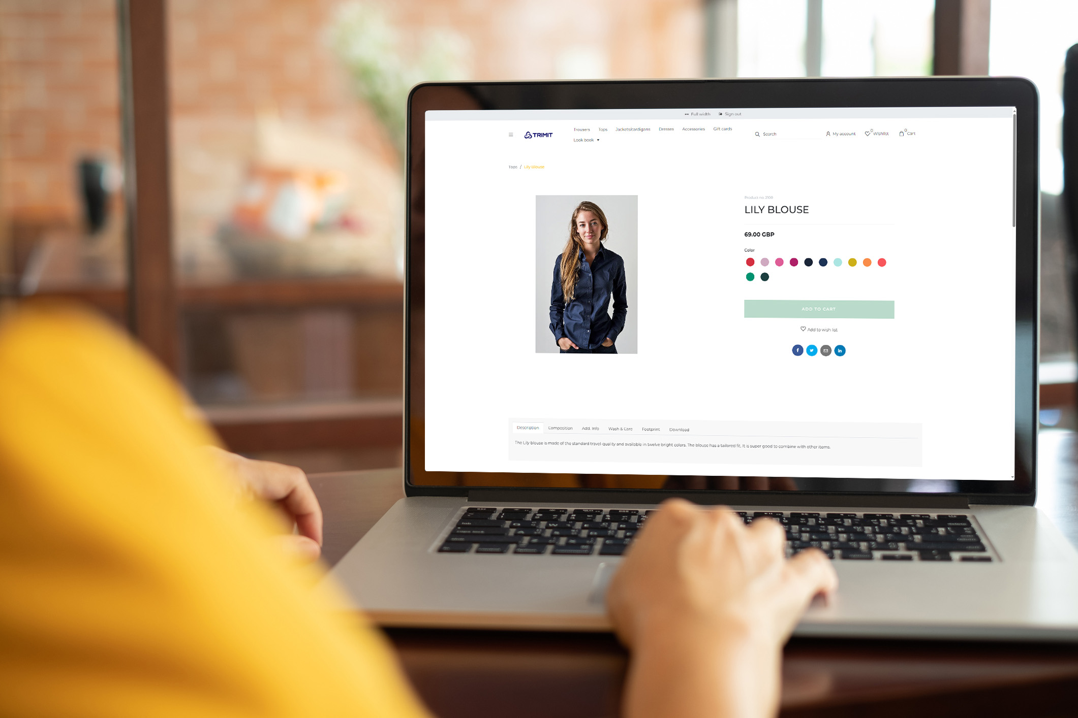 showing a close-up of a computer screen with the TRIMIT b2c site, showing a female model in a blue shirt